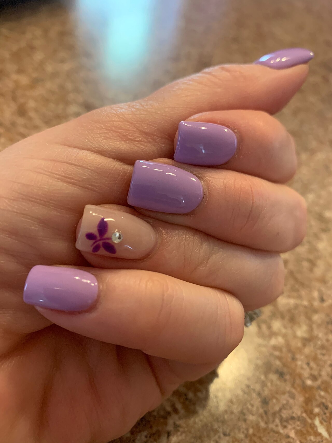 Detailed nail art with a crystal accent